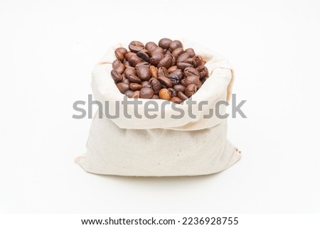 Burlap sack full of coffee beans isolated on white. Export and Import industry.