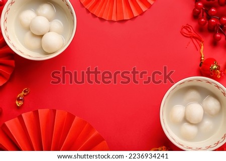 Frame made of bowls with tangyuan and Chinese decor on red background. Dongzhi Festival
