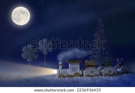New Year's background, a holiday card with a wooden train in the snow. christmas tree. Starry night.