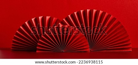 Happy Chinese New Year 2023 year of the rabbit concept. Oriental asian style paper fans on red table. Minimal style. Royalty-Free Stock Photo #2236938115