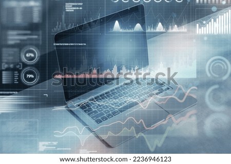 Close up of laptop computer with digital business graph hologram on blurry blue background. Trade, finance and analysis concept. Double exposure