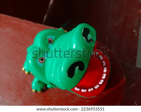 small green cute crocodile toy made of plastic