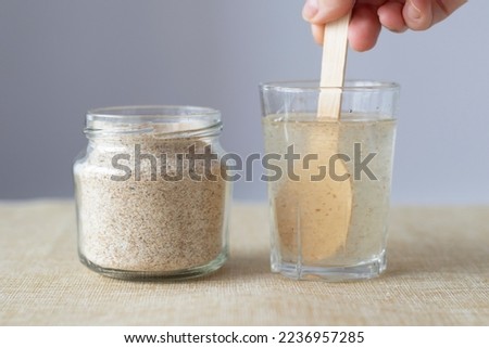 Supplement of psyllium husk and soluble fiber for the intestines. Mixing psyllium with water. Sustainability  Royalty-Free Stock Photo #2236957285