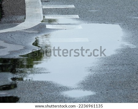 wet asphalt road after rain in street Royalty-Free Stock Photo #2236961135