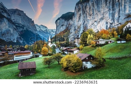 Incredible nature landscape. Amazing alpine village with famous church and Staubbach waterfall, Lauterbrunnen, Switzerland, Europe. Lauterbrunnen is a iconic location for landscape photographers. Royalty-Free Stock Photo #2236963631