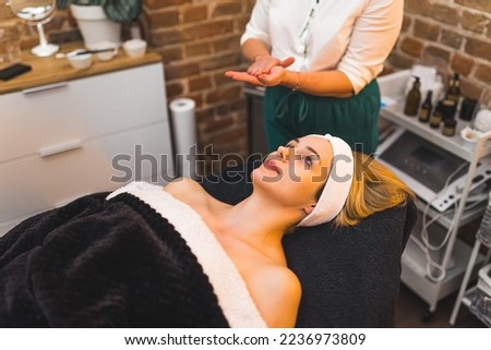 A woman laying on a spa massage bed in a beauty salon. High quality photo