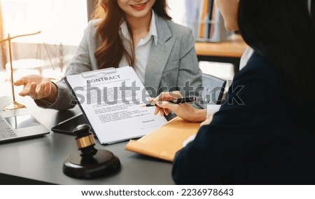 Business law concept, Lawyer business lawyers are consulting lawyers for women entrepreneurs to file copyright lawsuit with laptop and tablet at office 