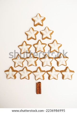 Assorted Christmas cookies in the shape of a Christmas tree on white background. Top view.
