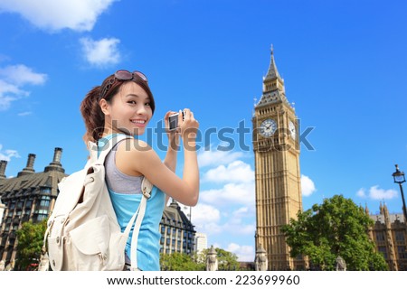 Happy woman traveler photo by camera in London with Big Ben tower,  London, UK,  asian beauty