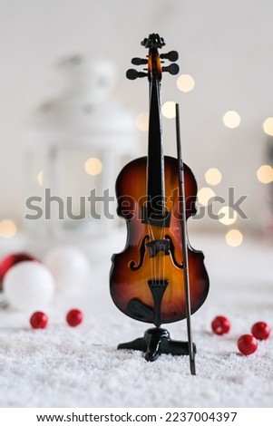 Violin toy with artificial flake in winter concept