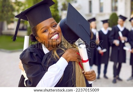 My happiest day. Two happy female students hugging during graduation ceremony at college or university. Close up of happy African American woman hugging her classmate congratulating her on graduation.