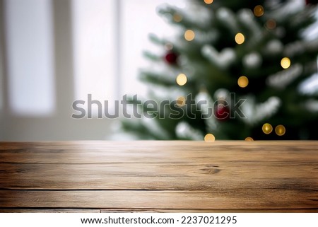 An empty wooden table with a Christmas tree in the background. Festive studio background for product presentation. 