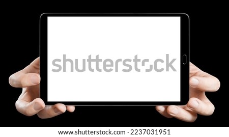 Tablet in male hands, isolated on black background
