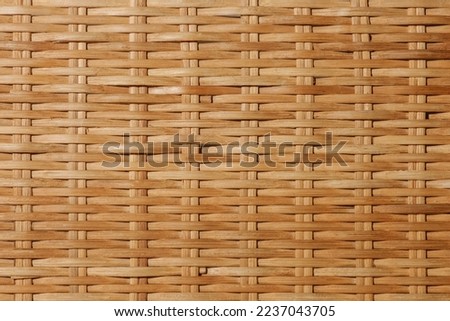 Traditional bamboo handicraft weaving pattern in Thailand. Thai wicker rattan texture pattern. Local handmade. Handmade woven rattan pattern. Wicker structure as a background. Royalty-Free Stock Photo #2237043705
