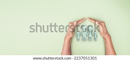 Hand holding covered 3d family symbolic icon, planning family protection by or family care and support concept