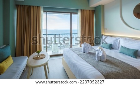 A hotel room with bright fresh colors in Bali style, minimal style bedroom with ocean view Royalty-Free Stock Photo #2237052327