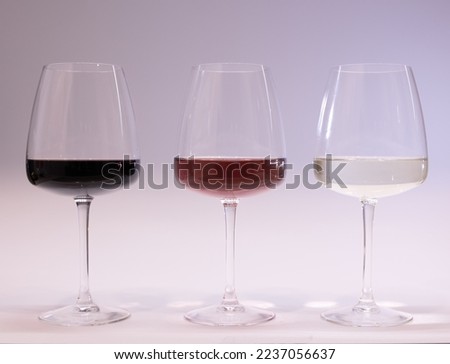Red, white and rose wine glasses up. White background