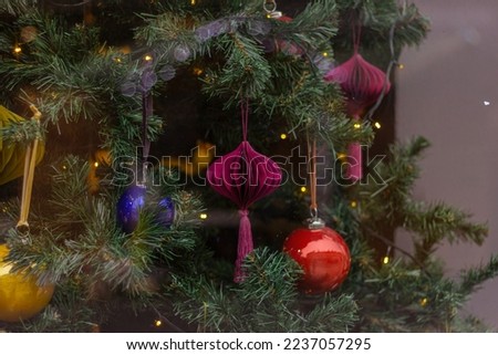 a decorated Christmas tree in the shop window. New Year design for holidays