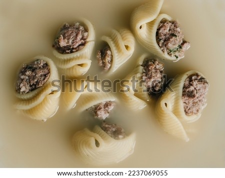 high angle view of some escudella de Nadal or sopa de galets, a soup with galets pasta, typically eaten on Christmas in Catalonia, Spain Royalty-Free Stock Photo #2237069055