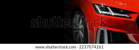 Red modern car headlights on black background 