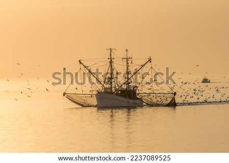 Fishing boat on the North Sea fishes with a trawl net, Schleswig-Holstein, Germany Royalty-Free Stock Photo #2237089525