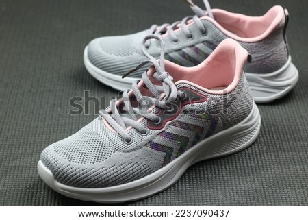 Grey Sport shoes on sport mattress. Indoor workout concept and healthy lifestyle. Sport equipment background.