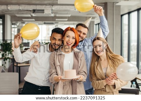Business woman celebrating birthday and doing a party with colleagues in her office.