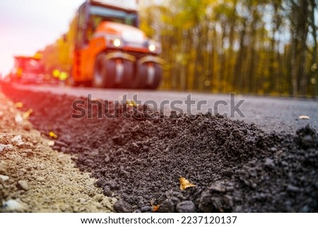 Industrial pavement truck. Laying fresh asphalt on construction site. Heavy machine industry. Mechanical engineering.