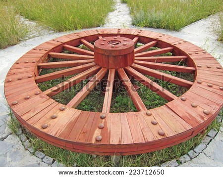Wooden wheels in a park, closeup of photo