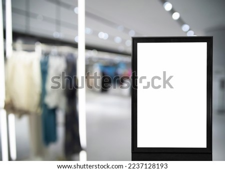 Blank advertising board in clothing store. Mockup for design