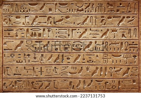 Old Egyptian hieroglyphs on an ancient background. Wide historical and culture background. Ancient Egyptian hieroglyphs as a symbol of the history of the Earth.  Royalty-Free Stock Photo #2237131753