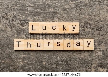 lucky thursday word written on wood block. lucky thursday text on cement table for your desing, concept.