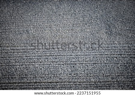 An interesting pattern has formed from a layer of frost that has settled on the top of a wooden picnic table. The resulting scene creates a background that is very wintery 