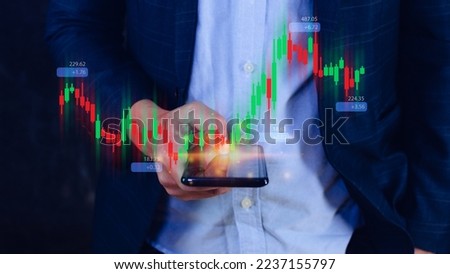 Hand of businessman or trader is showing growing virtual hologram stock on smartphone, planning and strategy, Stock market, Business growth, progress or success concept. invest in trading.