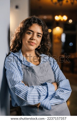Portrait picture of a waitress leaning on the wall