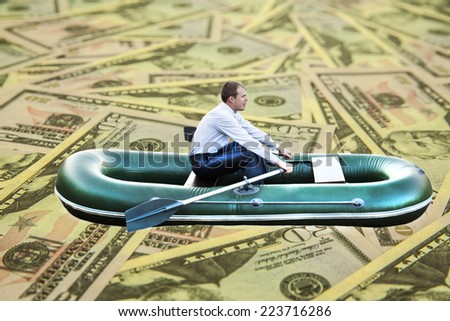 Image or photo of millionaire, human floats in rubber boat on money 50 backnote bill Dollars texture Copy space for inscription Male with paddle Empty copy space for inscription 