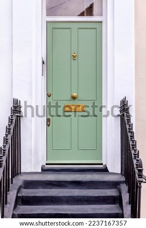 Classic green front door of European residence  Royalty-Free Stock Photo #2237167357