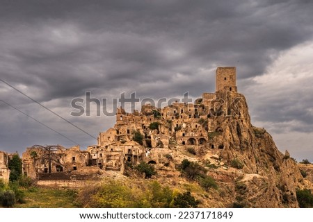 views of the Craco village with a cloudy sky in the background, Basilicata, Italy