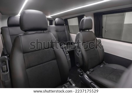 comfortable passenger bus interior with upholstered seats; individual transfer for a group of people; conversion of the interior of a truck;  Royalty-Free Stock Photo #2237175529