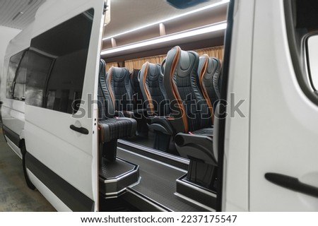 comfortable passenger bus interior with upholstered seats; individual transfer for a group of people; conversion of the interior of a truck;  Royalty-Free Stock Photo #2237175547