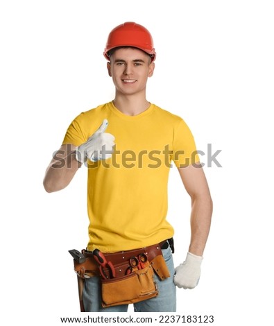 Handyman in hard hat with tool belt showing thumb up isolated on white Royalty-Free Stock Photo #2237183123