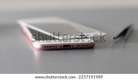 a person places a protective glass or film on a smartphone. copy space.