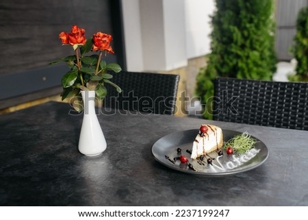 Classic simple New York cheesecake. A piece of cheesecake on a plate. Dessert with berries and chocolate. Dark background. Front view. Copy space.