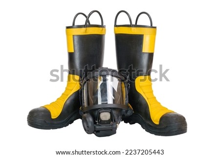 Pair of firefighter boots and full facepiece gas mask isolated on white background. High quality photo
