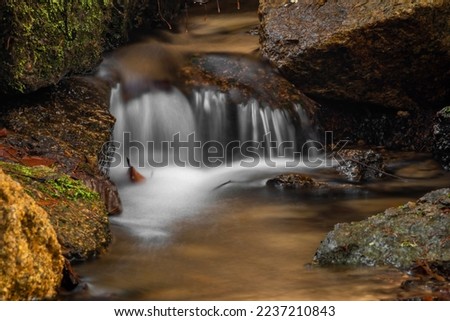Jizersky creek in winter cold day with color stones and clear fresh water in Liberec city