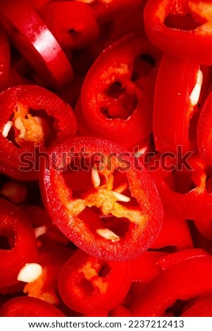 The texture of chopped chilli peppers as a background. A close shot of a chilli pepper. Macro photo. Fresh chopped chili peppers. Close-up.