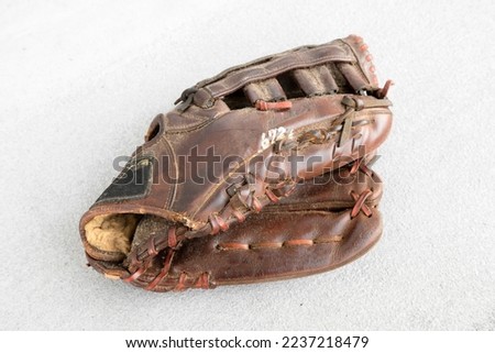 Tattered baseball glove used for many years.