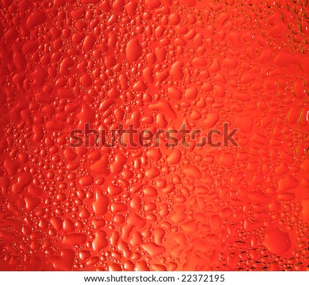 Water drops on red glass