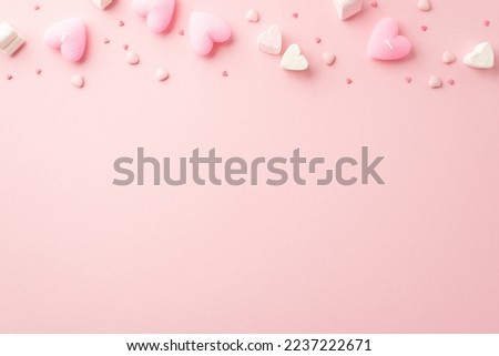 Valentine's Day concept. Top view photo of heart shaped marshmallow candles and sprinkles on isolated light pink background with copyspace Royalty-Free Stock Photo #2237222671