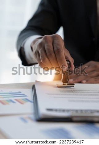Loan approver, businessman in suit, man using stamp for car loan approved Royalty-Free Stock Photo #2237239417